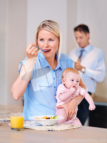 Image of Woman, breakfast and thinking with baby in morning for daily routine, planning and eating in kitchen. Mother, infant and standing in house with vision, ideas and nurture of child in family home