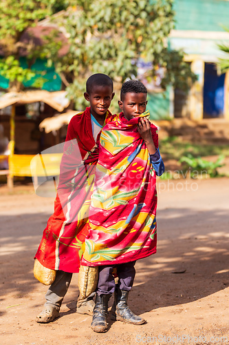 Image of Ethiopian teenagers covered with a blanket to keep out the cold. Demebecha, Ethiopia