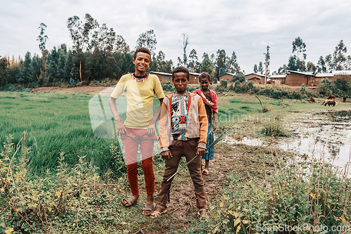 Image of Ethiopian teenagers covered with a blanket to keep out the cold. Demebecha, Ethiopia