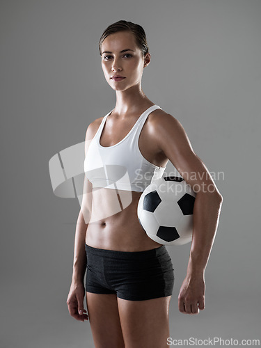 Image of Woman, portrait and soccer player with ball for match, game or kick off on a gray studio background. Female person or athlete with football for sports exercise, workout or training on mockup space