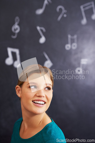 Image of Music, notes and face of woman on chalkboard for learning, teaching and musical education in classroom. Art school, creative and person thinking with signs for melody, sound and song for lesson