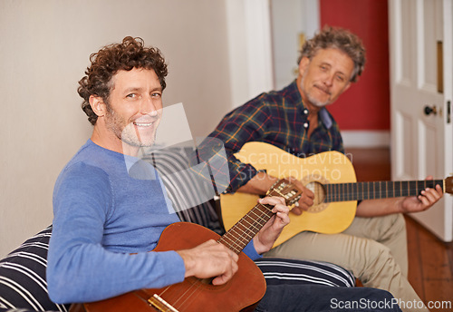 Image of Happy man, portrait and relax with family, guitar or music for acoustic sound or instruments at home. Young man playing or strumming with smile and father for classical audio on living room sofa