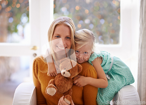 Image of Happy mama, portrait and hug with child or teddy bear for love, care or support together in living room at home. Face of mom, kid or daughter with smile for embrace, affection or mothers day at house