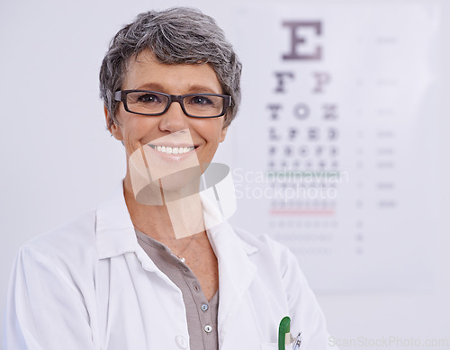 Image of Portrait, senior woman and optometrist smile for eye care, letter chart for exam with doctor at clinic. Alphabet, glasses for vision and prescription lens, assessment and ophthalmology for spectacles