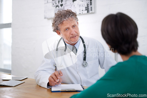 Image of Medical, consultation and mature doctor with a checklist for healthcare, insurance or results of test. Clinic, patient and man in discussion of surgery or exam and professional paperwork for hospital