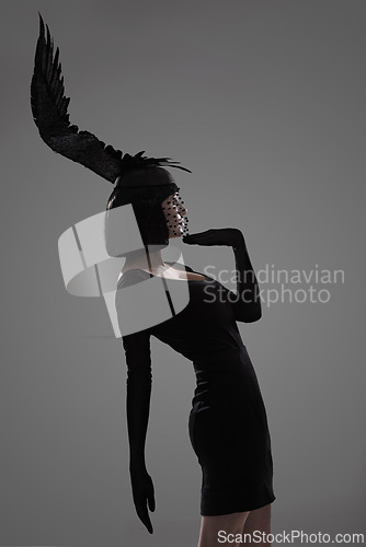 Image of Girl, feather and head for fashion in studio for fantasy or magic with unique creativity for art or illusion. Female person, isolated and white background for designer clothes, diva and surreal.