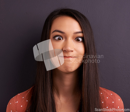 Image of Woman, funny face and studio for comedy expression as mockup space, grey background or humor. Female person, model and crazy emoji as meme for comic reaction with goofy good mood, carefree or squint