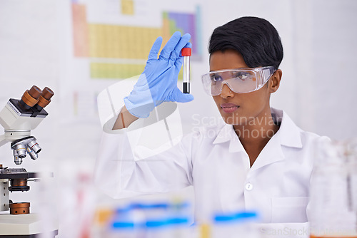 Image of Blood, dna and scientist with test tube in laboratory for scientific research or experiment. Medical, science and professional woman researcher with pharmaceutical dna in glass vial for medical study