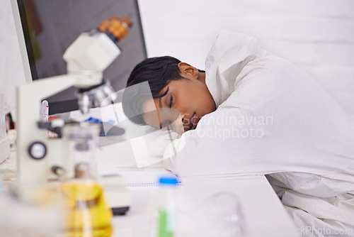 Image of Sleeping, tired and woman scientist in laboratory working overtime on pharmaceutical research. Exhausted, fatigue and female biology researcher with nap for burnout with medical project or study.