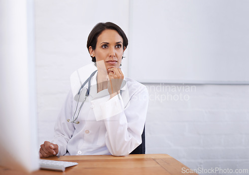 Image of Office, woman or doctor at computer thinking, brainstorming and ideas for healthcare in hospital. Online, research and medical professional at desk with insight, planning or problem solving in clinic