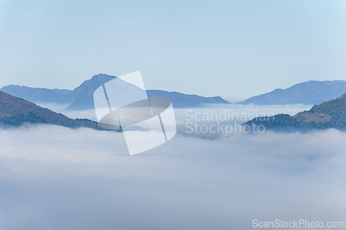 Image of Misty mountain morning: serene valley shrouded in ethereal fog a