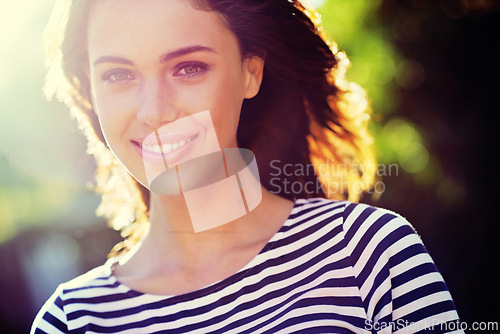 Image of Person, portrait and smile with nature, sunset and park for happiness and wellness. Woman, joy and sunshine with closeup, glow and happy for summer relax and adventure outside in garden with trees
