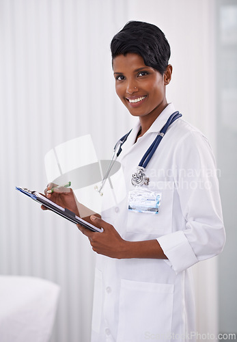 Image of Portrait, doctor and happy woman writing on checklist in hospital for healthcare career in India. Face, smile and medical professional with clipboard, employee or expert worker in clinic for wellness