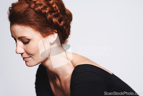 Image of Woman, hair care and braid crown for beauty, elegant hairstyle for glamour and redhead on white background. Profile, shine and texture, luxury or regal plait for cosmetics with model in studio