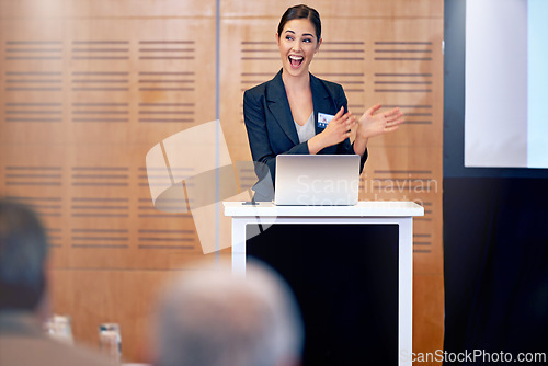 Image of Happy woman, laptop and business presentation with projector in meeting, discussion or seminar at conference. Young female person, employee or speaker talking on podium to group in corporate workshop