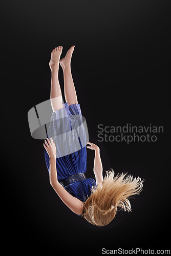 Image of Woman, fall and depression with despair in anxiety, stress or mental health on a dark studio background. Body of female person dropping upside down in air for nightmare, distress or dream into abyss