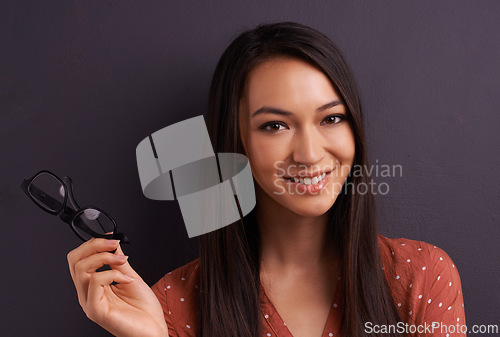 Image of Woman, portrait and glasses in studio for vision prescription with confident smile, grey background or mockup space. Female person, eyewear and frame for healthy optometry, eye care or spectacles