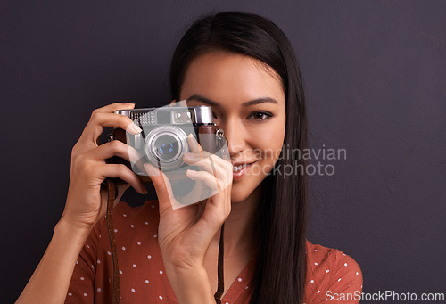 Image of Woman, portrait and film camera for photography in studio for vintage creativity, grey background or mockup space. Female person, face and equipment for picture career or memory fun, lens or photo