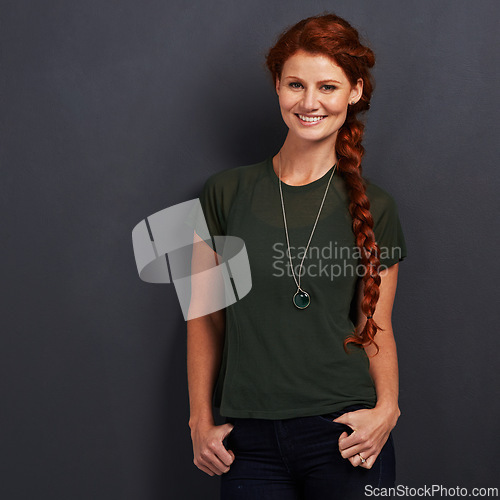 Image of Portrait, ginger and happy woman in studio for fashion isolated on dark background mockup space. Confidence, smile and person with red hair in casual clothes, tshirt or stylish on backdrop in Ireland