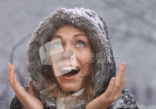 Image of Nature, excited and face of woman with snow outdoors for season, snowing weather and cold climate. Travel, happy and person with snowflake on winter holiday, vacation and weekend in Switzerland