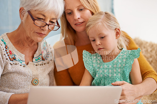 Image of Family, laptop and internet at a home with grandmother, girl and mother together with game. Learning, online and senior woman with child and mom with love, support and care in a house with tech