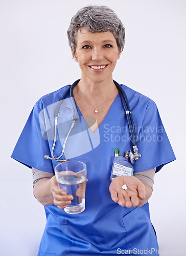 Image of Senior woman, doctor and water with pills, healthcare with medication treatment and supplements on white background. Vitamins, medicine and pharmaceutical drugs with physician for health in studio