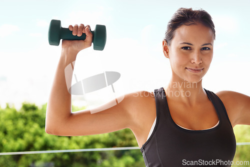 Image of Woman, portrait and dumbbell exercise for weightlifting workout on balcony for gym fitness, sports or performance. Female person, face and sport strength for health in nature, wellness or training