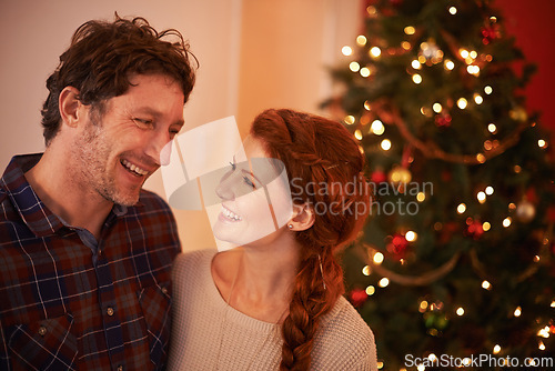 Image of Couple, smile and Christmas, holiday celebration with festive season of giving for love and commitment. Happiness, hug and support with people at home for tradition, romance and relationship