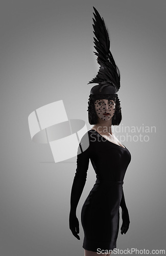 Image of Woman, feather and art for fashion in studio for fantasy or magic with unique creativity for art or illusion. Female person, isolated and white background for designer clothes, diva and surreal