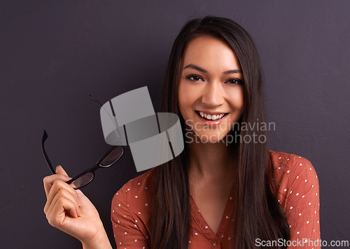 Image of Woman, portrait and glasses in studio for eye care prescription with confident smile, grey background or mockup space. Female person, vision and frame for healthy optometry, eye care or spectacles