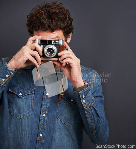 Image of Vintage, fashion or photography by man, camera lens or capture of creative, graphic or style. Male photographer, film or retro gadget as trendy, denim or urban outfit in studio on grey background