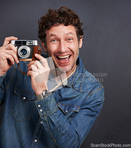 Image of Portrait, man or vintage camera in fashion, photography or capture of creative, graphic or style. Male photographer, retro gadget or film in trendy, stylish or denim in studio on grey background