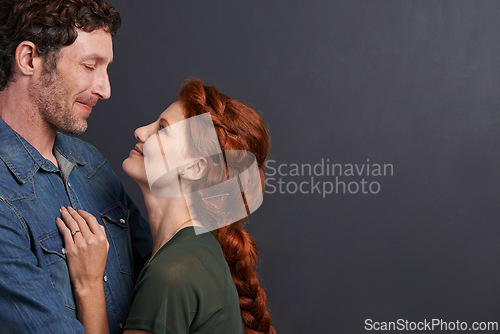 Image of Love, smile and happy couple in studio mockup together with relationship trust, care and support. Romance, man and woman embrace on dark background with commitment, loyalty and affection in marriage