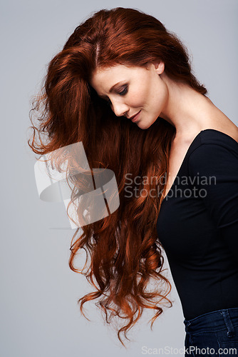 Image of Woman, haircare and healthy with treatment in studio on grey background with satisfied look and confidence. Red hair, female person and wellness with conditioner for routine, repair and fresh