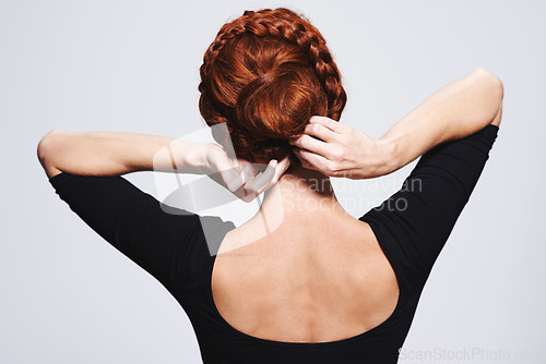 Image of Back of woman, hair and braid hairstyle for beauty, elegant redhead with glamour and cosmetology on white background. Haircare, luxury or regal, hands fixing plait or twist for cosmetic care