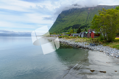 Image of Serene morning by the fjord with colorful fishing cabins in norw