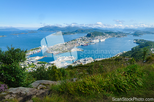 Image of Majestic vista of a coastal town nestled among islands under a c