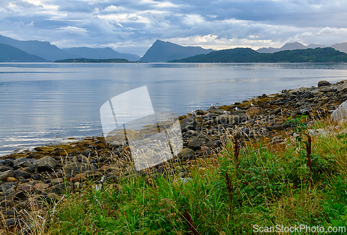 Image of Tranquil waters and rocky shores: a serene scandinavian twilight