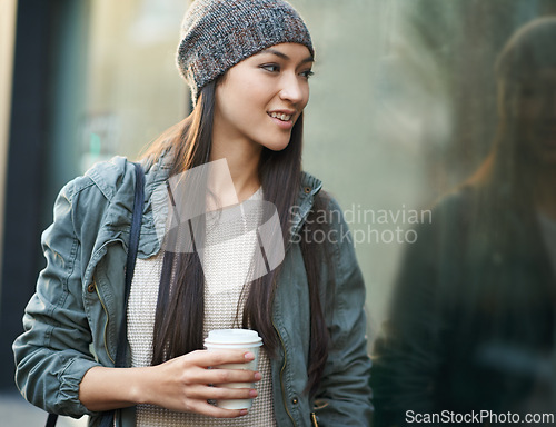 Image of Woman, fashion and window with city, coffee and urban street or background for style. Female student, beanie and jacket in cape town with winter, cold and travel with morning commute for confidence