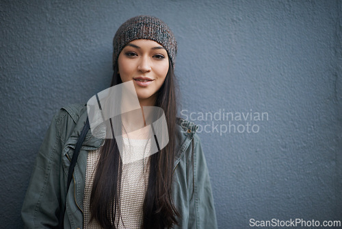 Image of Woman, beanie and jacket with portrait, confidence and urban fashion or street style. Female student, denim and cold with trendy, winter and cape town adventure or holiday on grey wall background