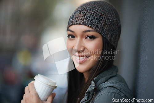 Image of Portrait, city and smile with woman, coffee and relaxing with winter season and wool cap. Face, person and girl with tea and cappuccino with urban town and knitted beanie with happiness in a street