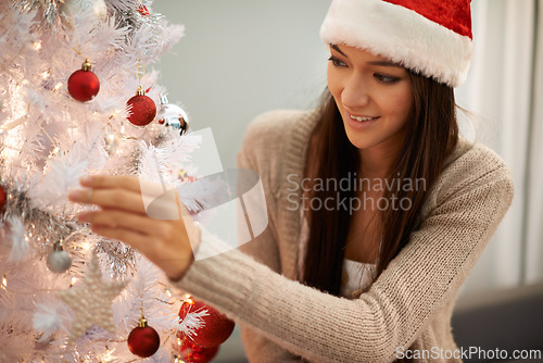 Image of Excited, christmas tree and woman decorating at her home for festive party, event or celebration. Happy, holidays and young female person with xmas ornaments for decoration at apartment or house.