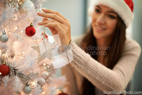 Image of Happy, christmas tree and woman decorating at her home for festive party, event or celebration. Smile, holidays and young female person with xmas ornaments for decoration at apartment or house.