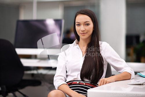 Image of Smile, portrait and business woman in office with positive, good and confident attitude. Happy, pride and professional female designer sitting by desk for working on creative project in workplace.