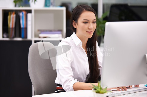 Image of Woman, office and pc in desk with smile for work with typing notes, documents and online schedule as assistant. Administration, female person and happy on computer for internet or website for search.