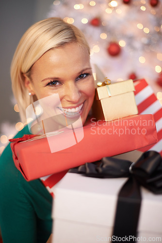 Image of Woman, portrait and Christmas gifts at tree for holiday giving for festive season celebration, event or packaging. Female person, face and excited or vacation break with present, giveaway or prize