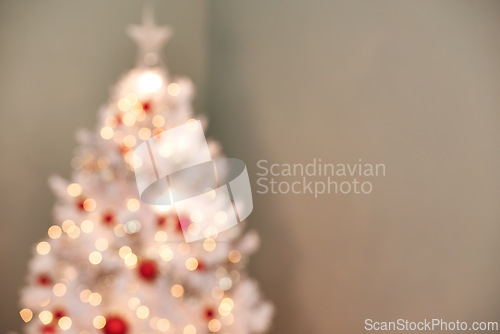 Image of Christmas, tree and decorations in living room with blur, holiday or preparation for festive season. Morning, bokeh and tradition for celebration, xmas and December winter vacation in apartment