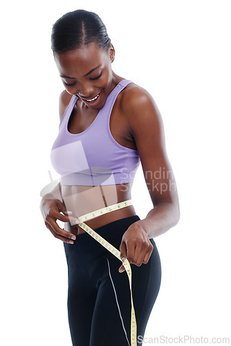 Image of Fitness, tape measure and waist with happy black woman in studio isolated on white background for weight loss. Exercise, smile and diet with young sports model training for health or nutrition