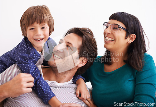 Image of Happy family, portrait and love on sofa to relax, weekend and bonding together in living room. Parents, boy child and smile face for affection in trust, embrace and parent support on vacation in home