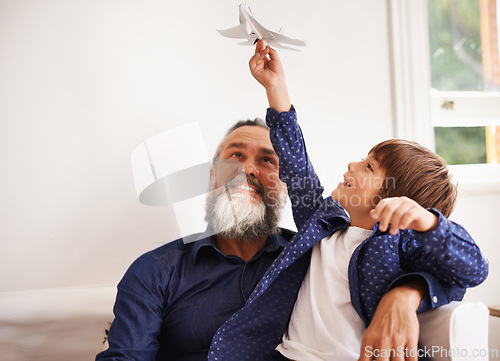 Image of Grandpa, kid and playing with toy airplane in home, love and bonding together on vacation in living room. Happy family, boy and grandfather with jet game in lounge, relax and care on school holiday